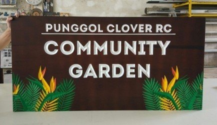 Engraved wooden sign example in brown paint finish with painted graphics